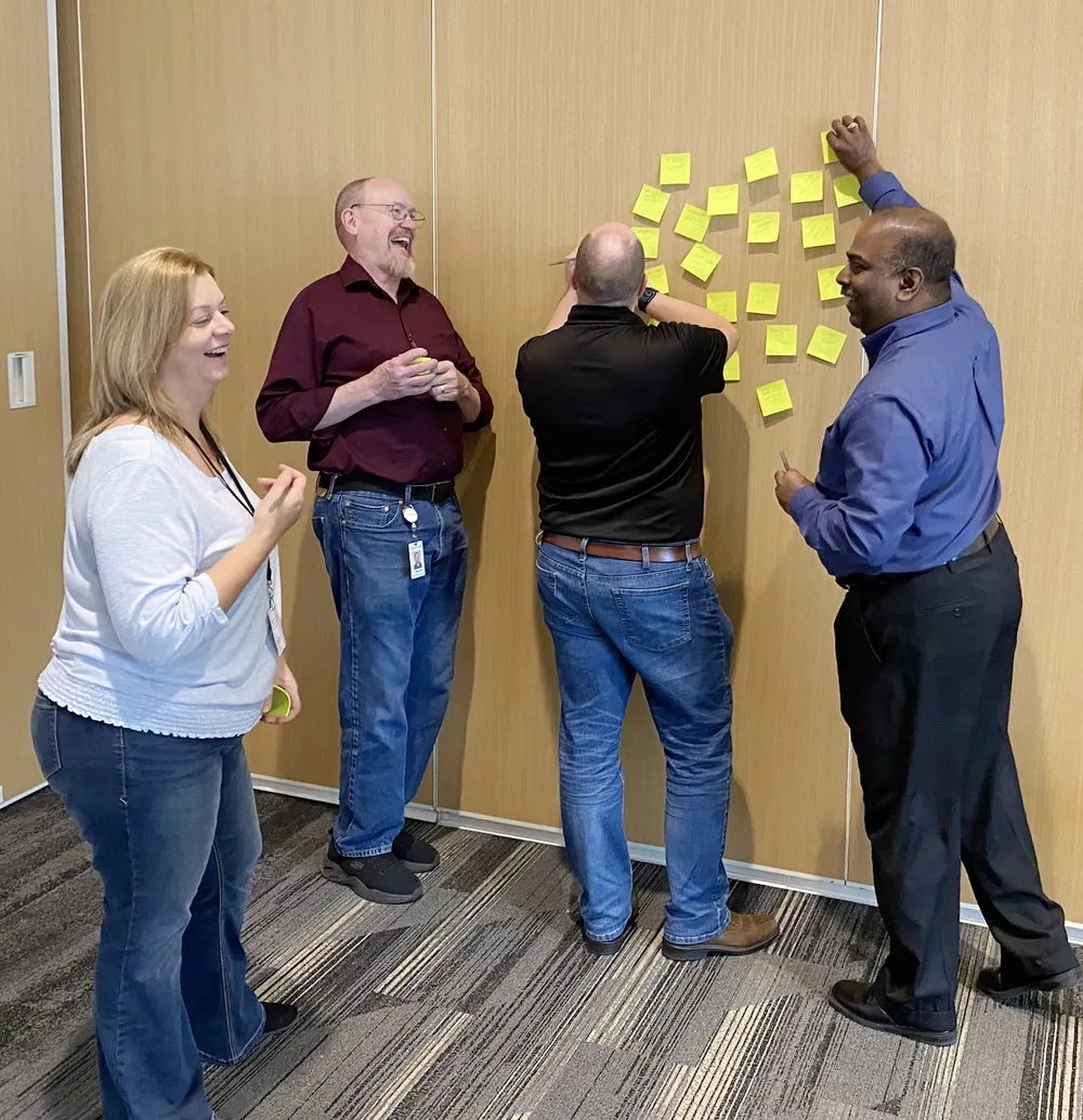 Team members collaborating energetically during a creative brainstorming workshop