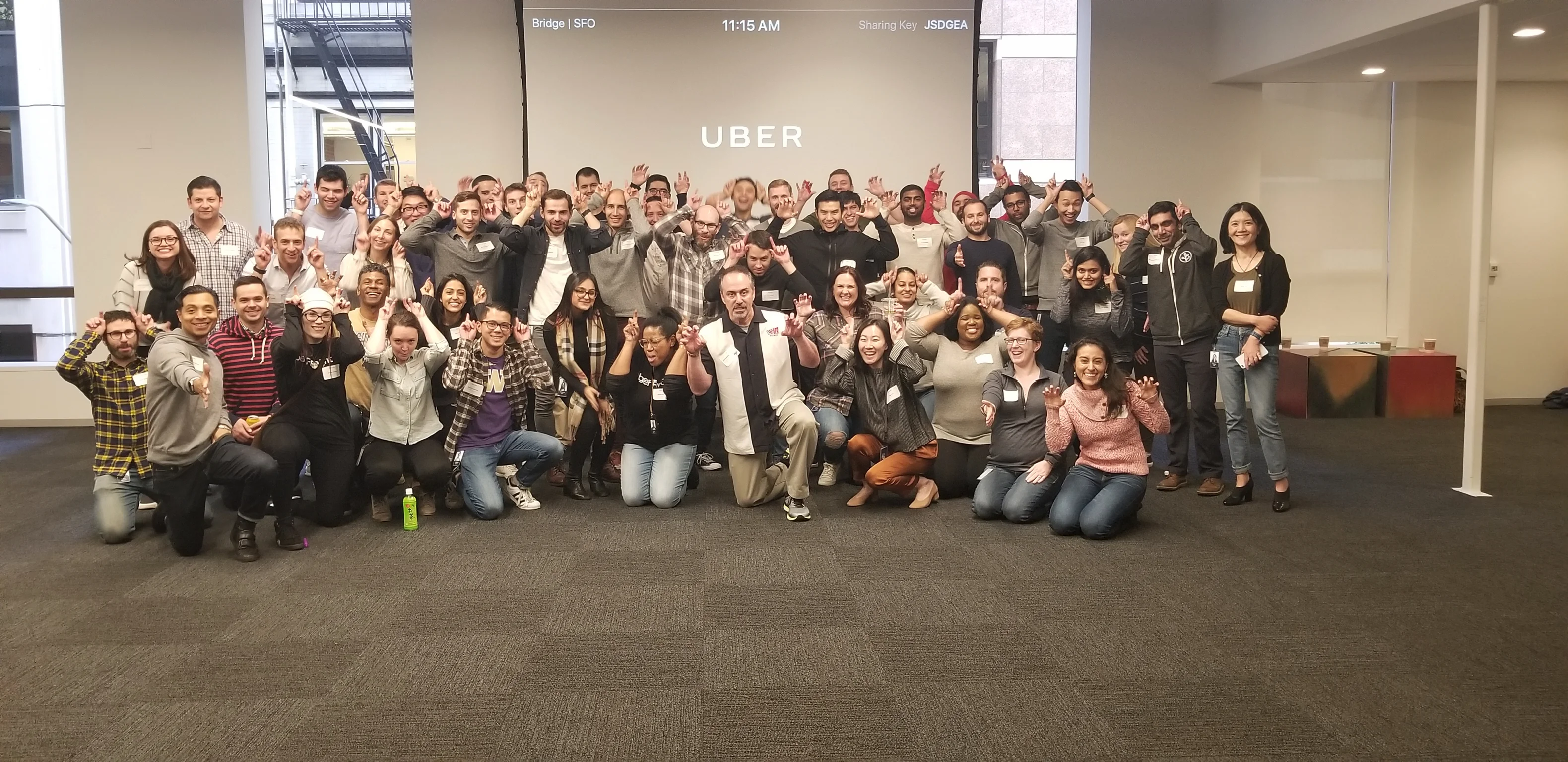 A large group of approximately 50 Uber employees energized at the conclusion of a CSz Portland applied improv workshop